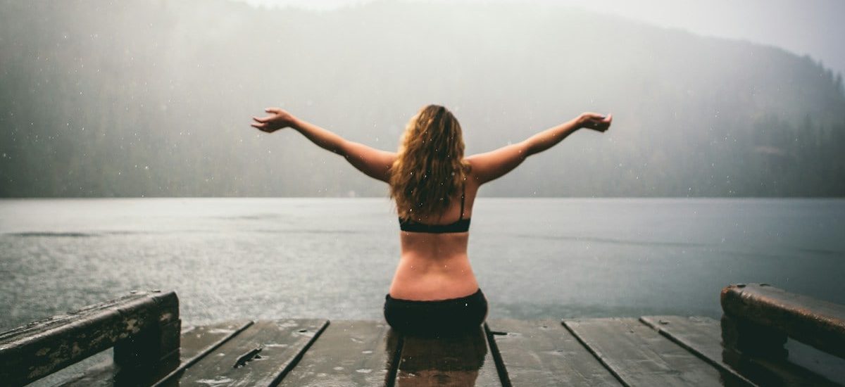 woman sitting on wooden dock
