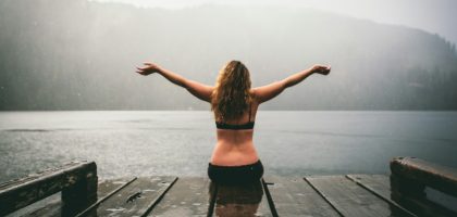 woman sitting on wooden dock
