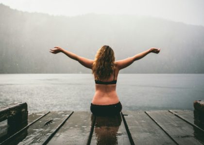 woman sitting on wooden dock